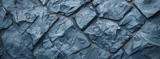 Blue-grey basalt rock wall texture with rough cracks and crumpled stone surface