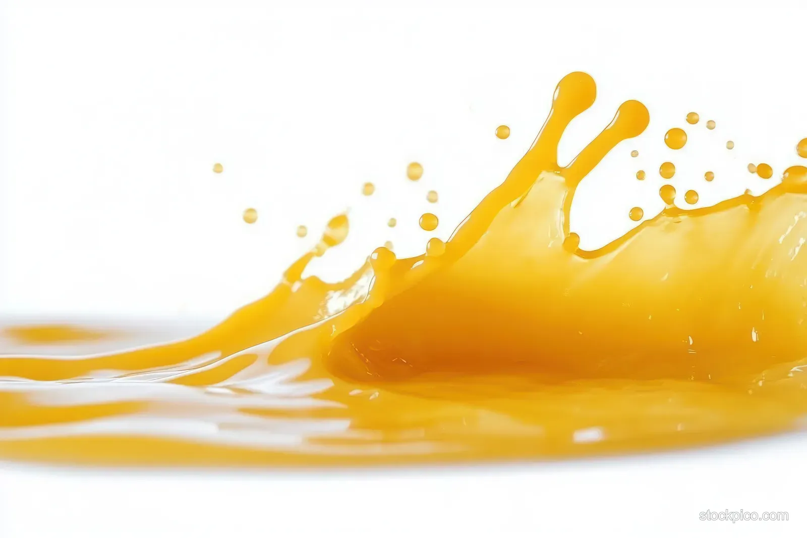 Orange juice splash with suspended droplets flowing across a clean white background.