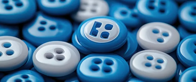 A pile of blue and white buttons with a baseball team logo button in the center on a table.