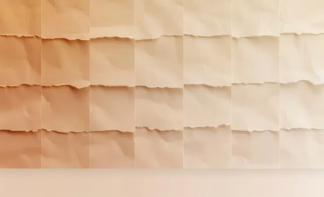 Rows of torn beige paper strips creating a light-to-dark gradient with soft shadows