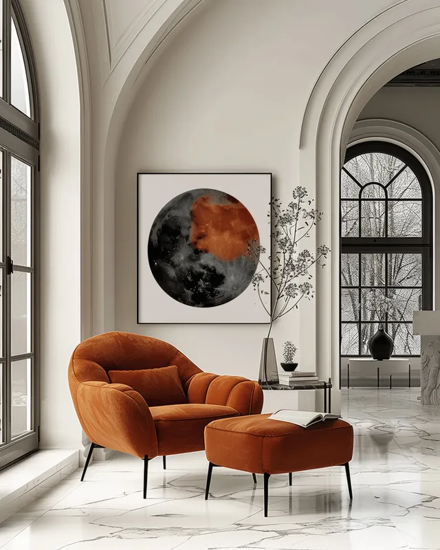 Orange armchair and matching ottoman sit beside a small table in a bright living room with arched windows and marble flooring.
