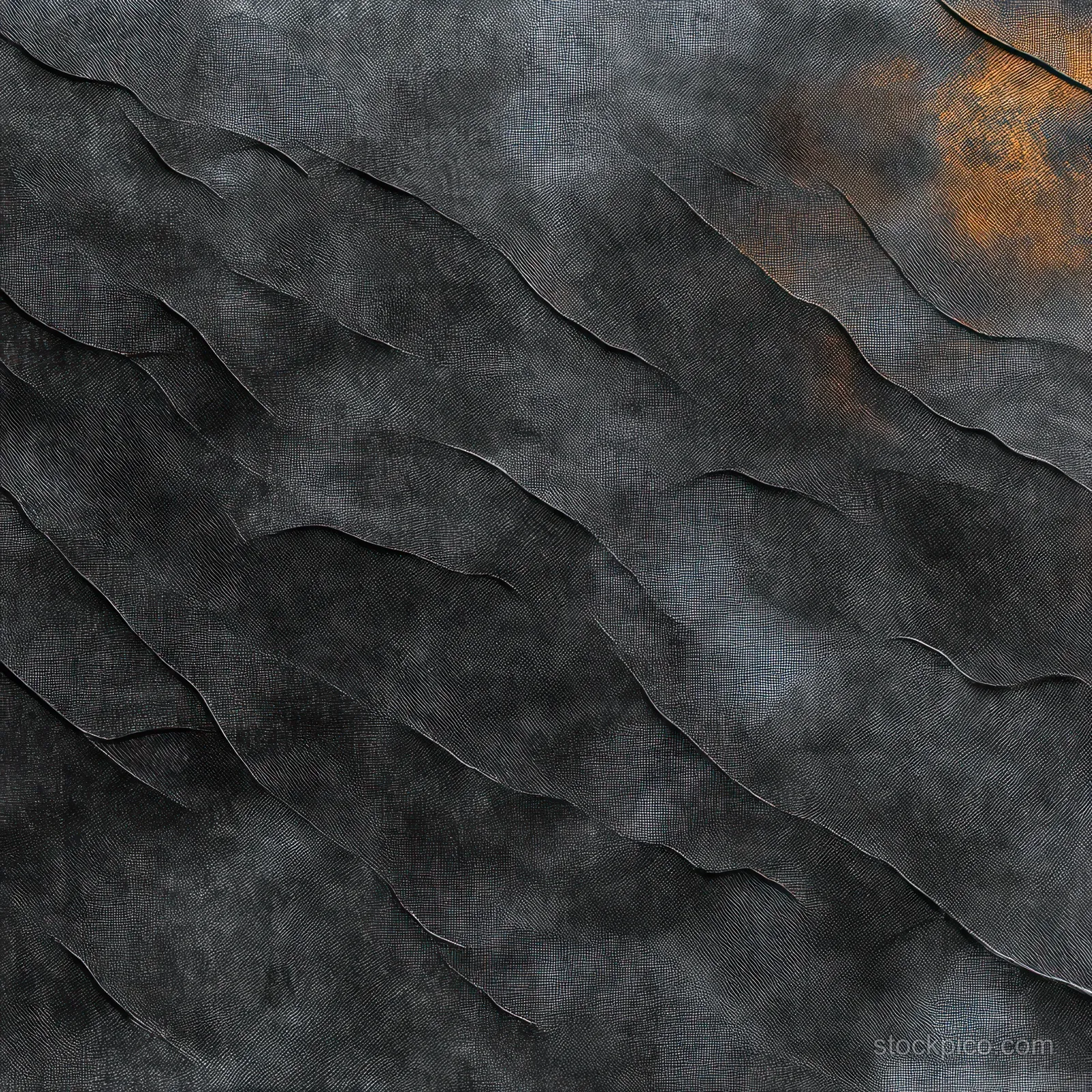 Close-up view of a gray fabric surface with layered folds and subtle gradient shading.