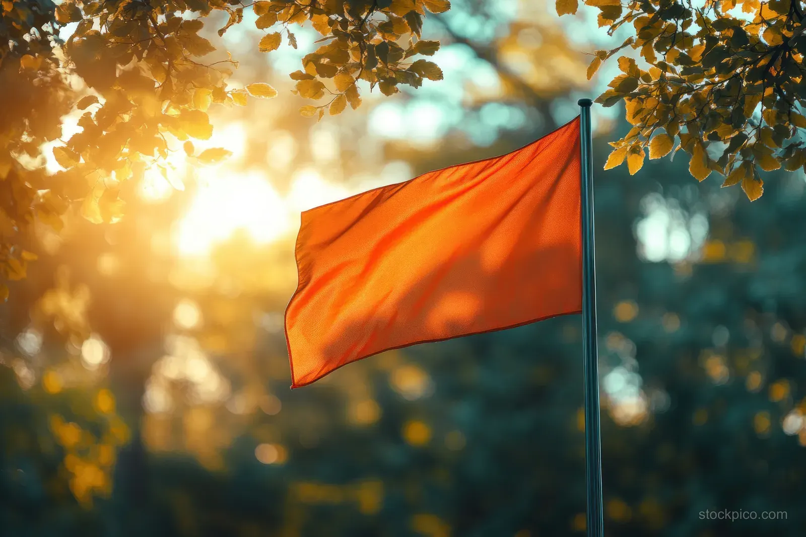 Polish flag waves on a balcony railing while sunlit green trees and blurred leaves fill the background.