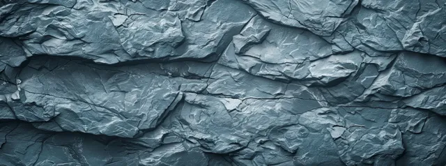 Abstract gray stone texture with a rough, cracked surface, suitable for various design layouts and backgrounds.