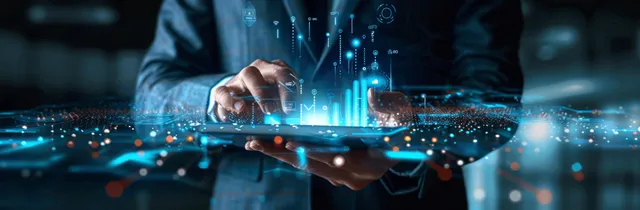 A businessman holds a tablet showing hologram security icons over a glowing cybersecurity interface.