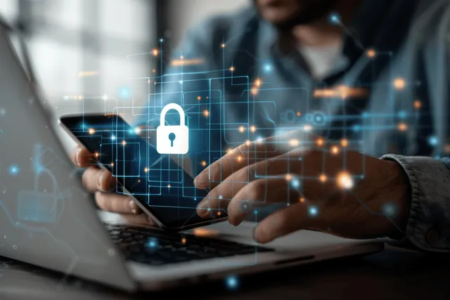 Hands typing on laptop with padlock icon and encrypted network lines