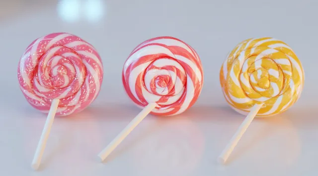 Three round swirl lollipops with red, pink, and yellow candy spirals on a light surface.