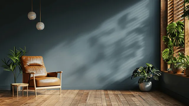 Dark living room with leather armchair, wooden floor, and potted plants by wall