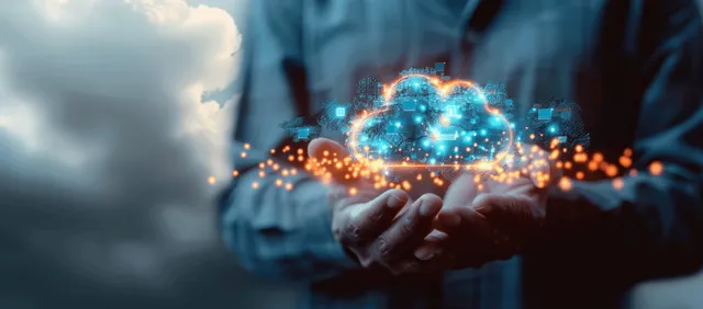 A businessman holds a glowing holographic cloud icon with surrounding digital data points.