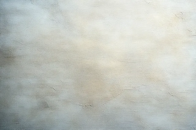 Close-up of a cracked plaster wall with uneven beige and pale gray paint texture and fine surface wear.