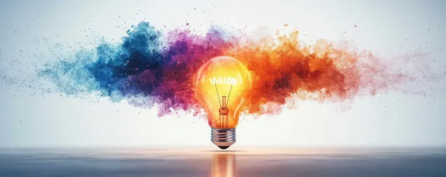 Glowing incandescent bulb emits blue purple red and orange powder clouds over a reflective surface.