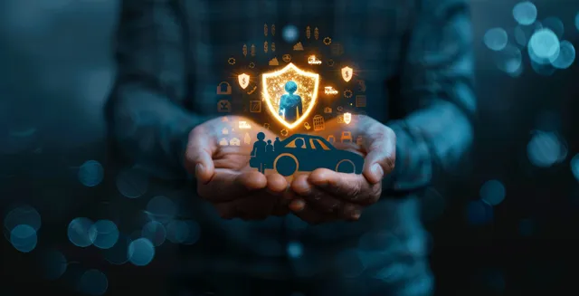 Hands presenting a glowing shield icon with insurance protection concept on a dark digital background.