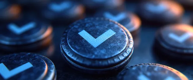 Blue checkmark badges on coins with shallow depth of field
