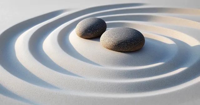 Zen garden stones resting in rippled sand, calm meditation rings