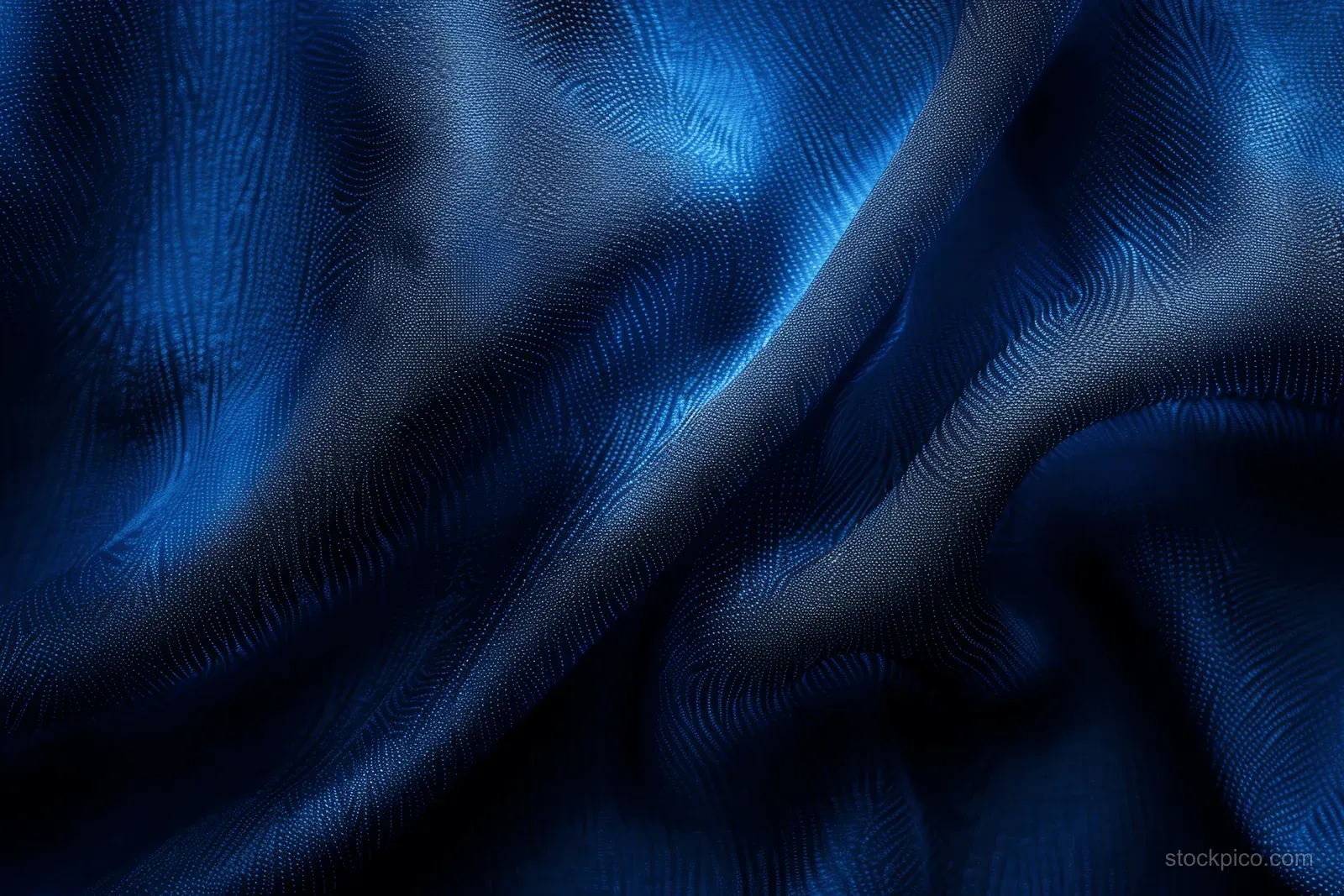 Deep navy silk fabric background with soft wavy folds and subtle shimmering highlights across the surface.
