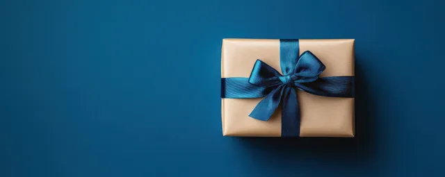 Gift box with blue ribbon centered on minimalist dark blue background