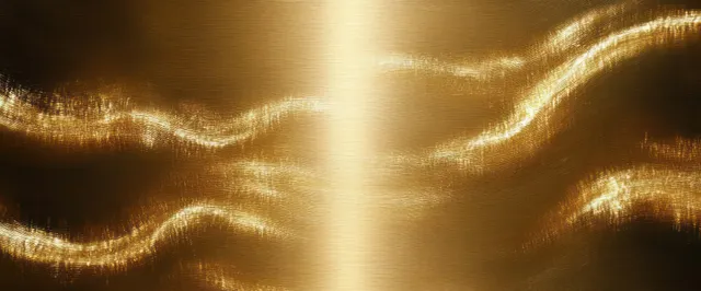 Close-up of a polished gold metal surface with brushed wave texture and glowing reflective highlights.