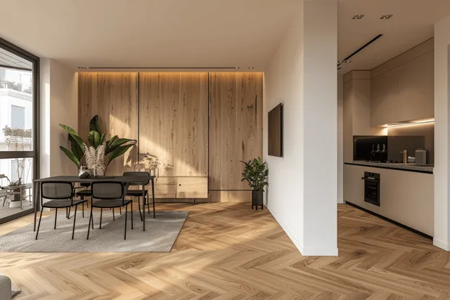 Black dining set sits in front of a warm wooden accent wall in a bright apartment with a visible kitchen.