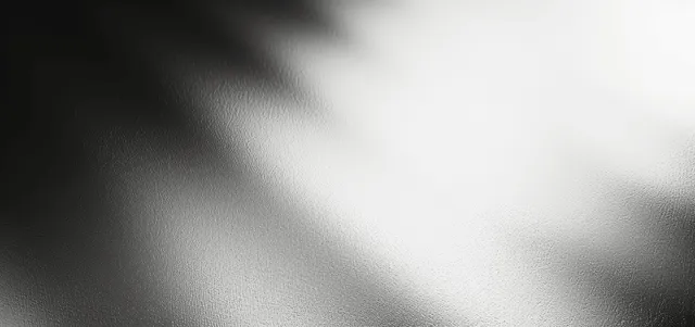 Silver monochrome gradient background with soft metallic blur, smoky highlights, and subtle grain texture.