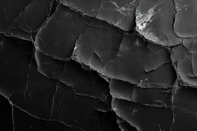 Cracked black surface with peeling texture and irregular abstract edges
