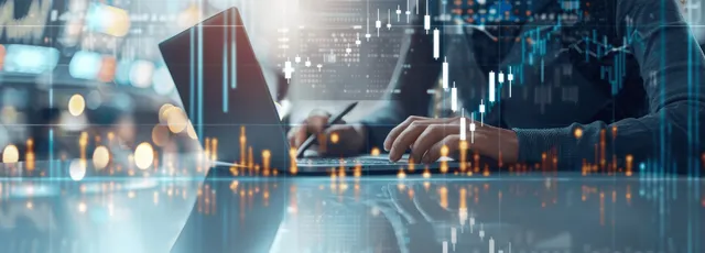 A hand adjusts illuminated trading graphs and candlestick data overlays over a blurred city financial background.
