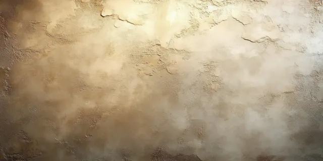 Warm lit textured plaster wall with vintage patina and rough natural imperfections