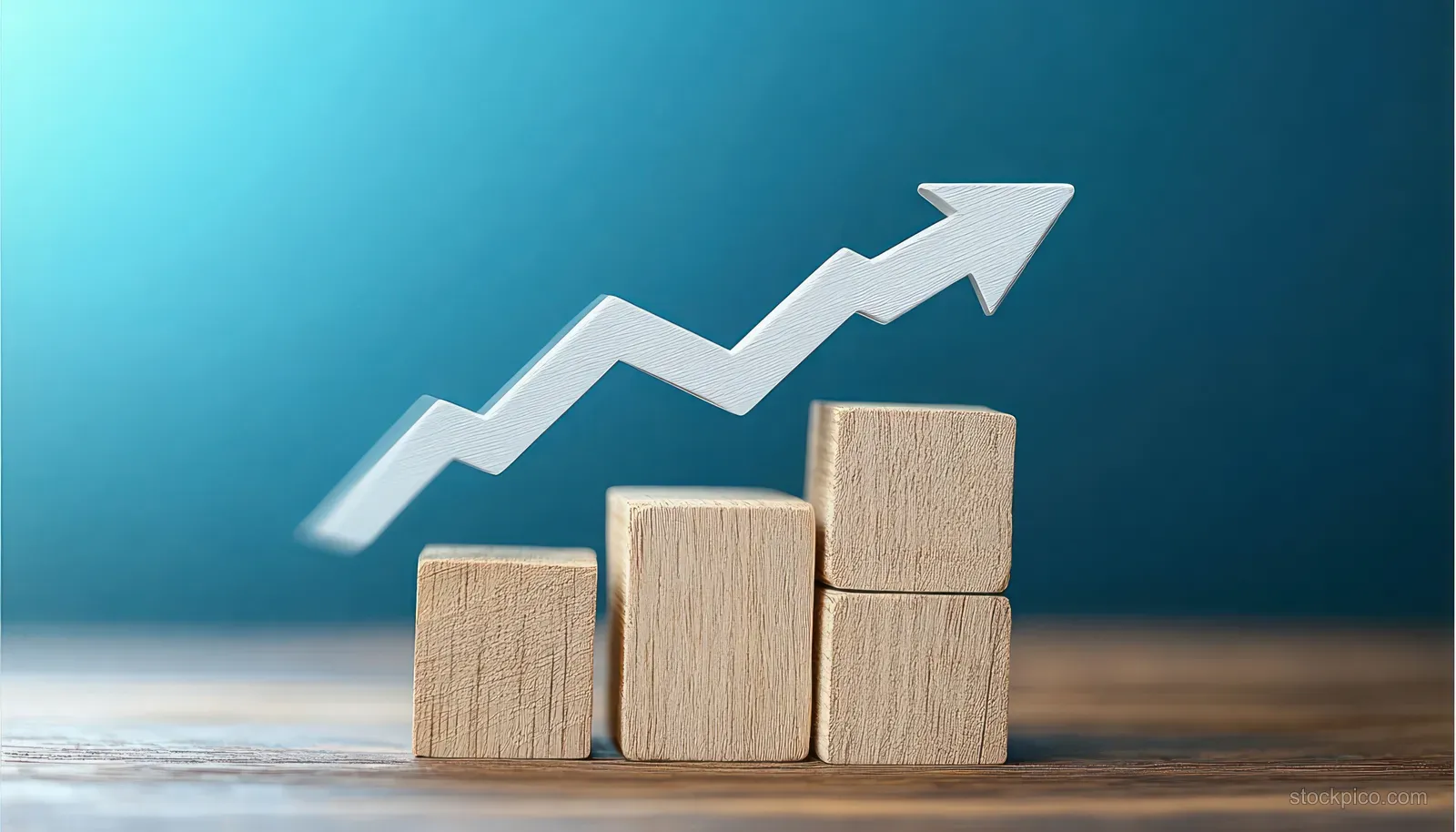 Wooden blocks stacked upward with a white upward arrow over a blue gradient background.