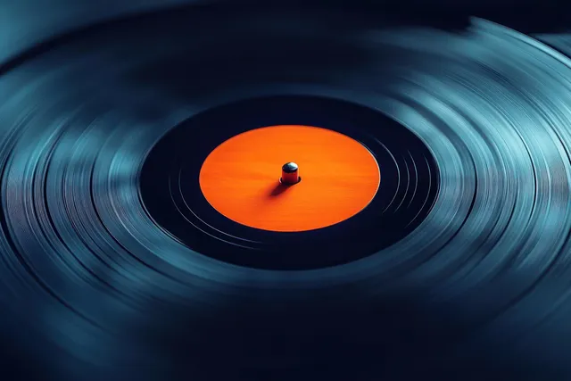 Spinning vinyl record on turntable with vivid orange label and reflective grooves