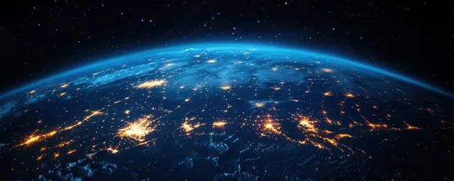 Satellite view of Eastern Asia at night with glowing city lights and curved Earth horizon