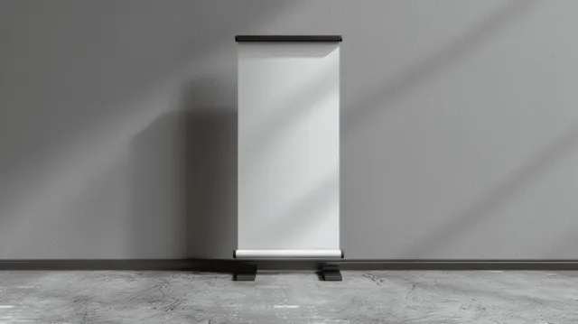 White roll-up banner stand mockup centered on a grey floor with an empty front panel.