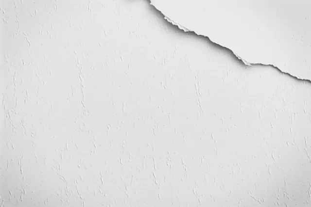 Torn vintage paper with grunge wrinkles and an open white space for text.