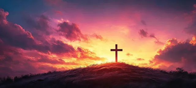 A silhouetted cross stands on a hilltop against a glowing orange and purple sunset sky.