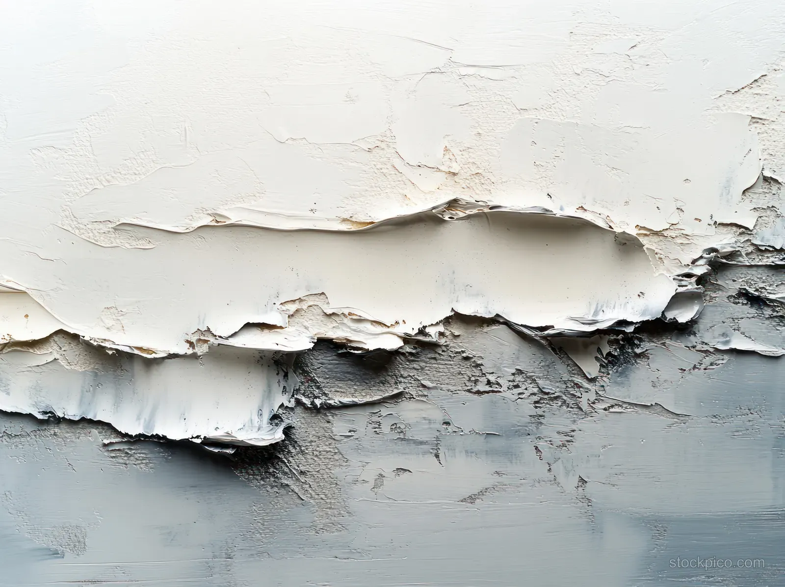 Torn white paint reveals a silvery layer with visible texture across a canvas surface.