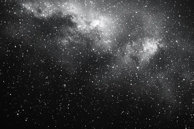 Black and white star field with dense clusters and cloudy nebulae over deep space darkness