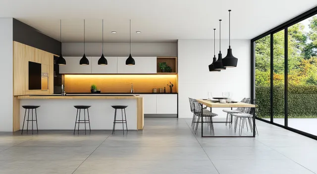 Scandinavian kitchen and dining area with white cabinetry, wooden island details, black pendant lights, and large glass doors to greenery.