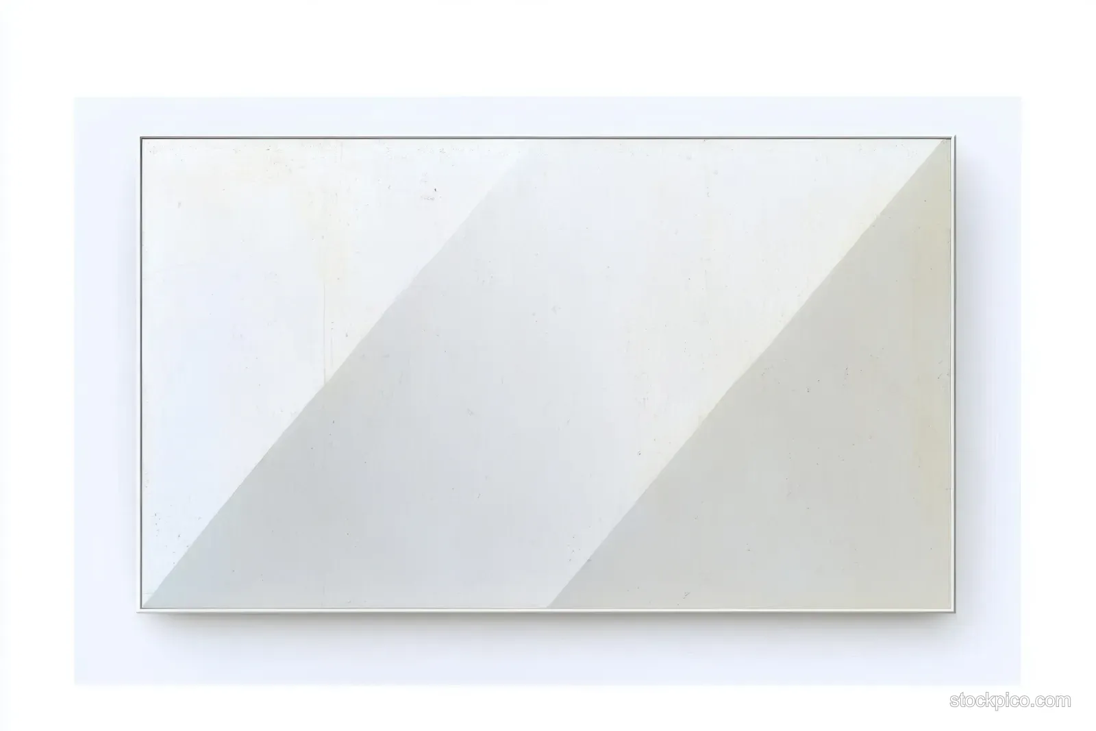 Framed blank white canvas on a white wall with a soft diagonal shadow across it.