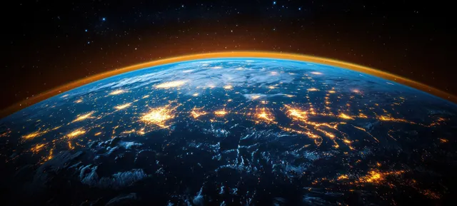 Earth seen from space at night with glowing city lights, dark ocean, and stars in the background.