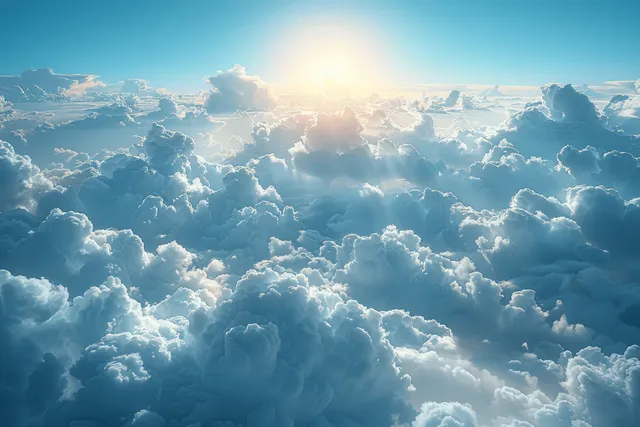 Sunrise light streams over layered fluffy clouds, casting warm highlights and cool blue shadows.