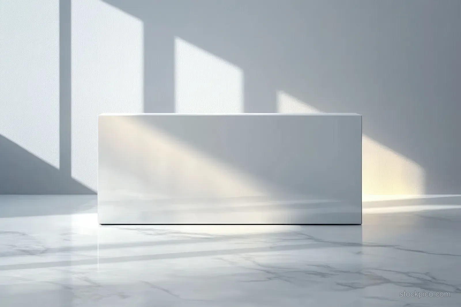 A white rectangular box rests on a polished marble floor with soft geometric sunlight shadows across a blank wall.