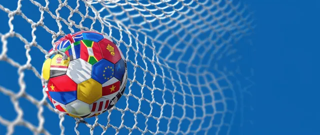 European flag patterned soccer ball positioned behind a goal net with a blue stadium background.