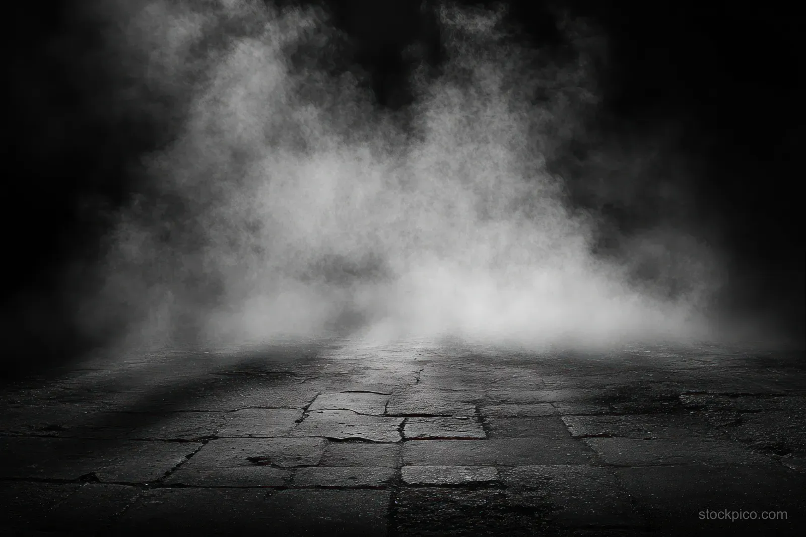 Cracked stone pavement with thick white mist rising into a dark background.