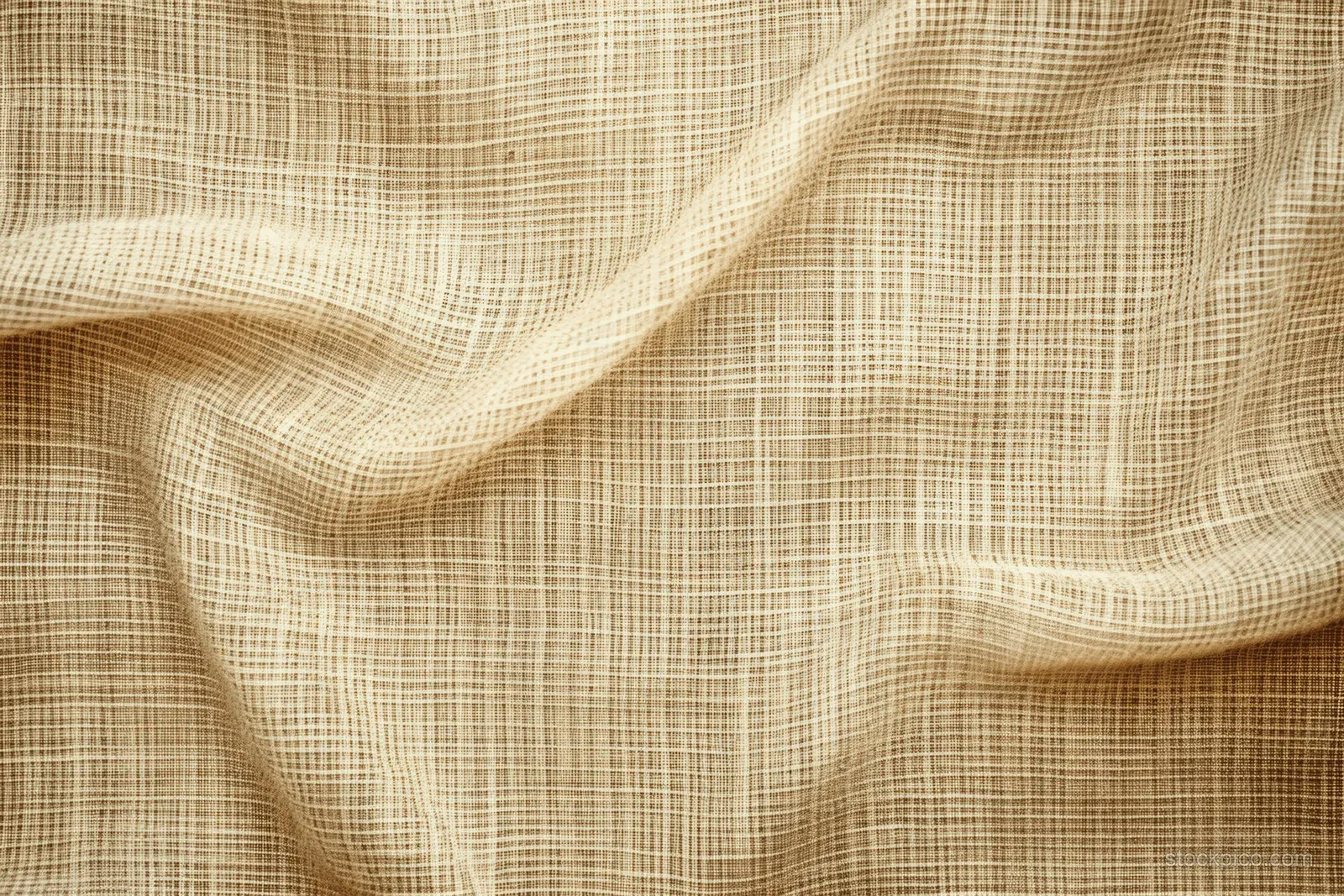Light brown jute hessian sackcloth with visible woven texture draped over a cream fabric background.