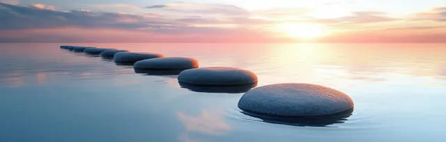 Smooth stones aligned on calm sunrise water with soft pastel reflections