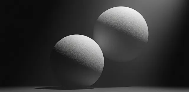 Dos esferas blancas minimalistas sobre un fondo oscuro con un suave degradado granulado y resplandor.