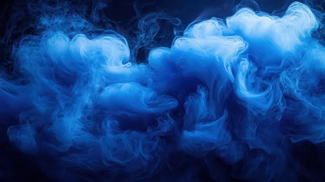 Swirling blue smoke curls and waves across a dark background with soft, translucent wisps.