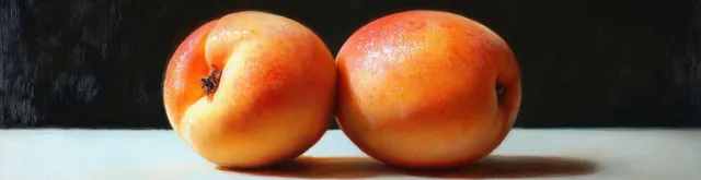 Two peach halves on dark background with glossy cut surfaces and soft light