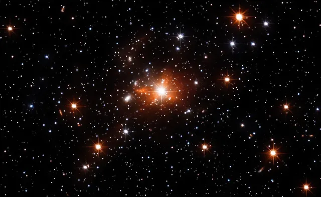 Twinkling stars and orange glowing nebula clouds fill a dark deep-space background.