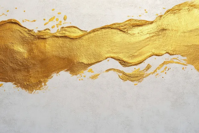Gold brush stroke abstract ribbon across textured white background with speckled paint flecks