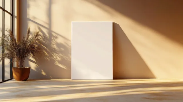 Empty minimalist interior with blank white canvas and potted plant under warm sun shadows