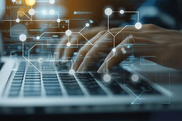 A hand near a laptop keyboard with a translucent glowing workflow flowchart of connected nodes overlaying the screen.